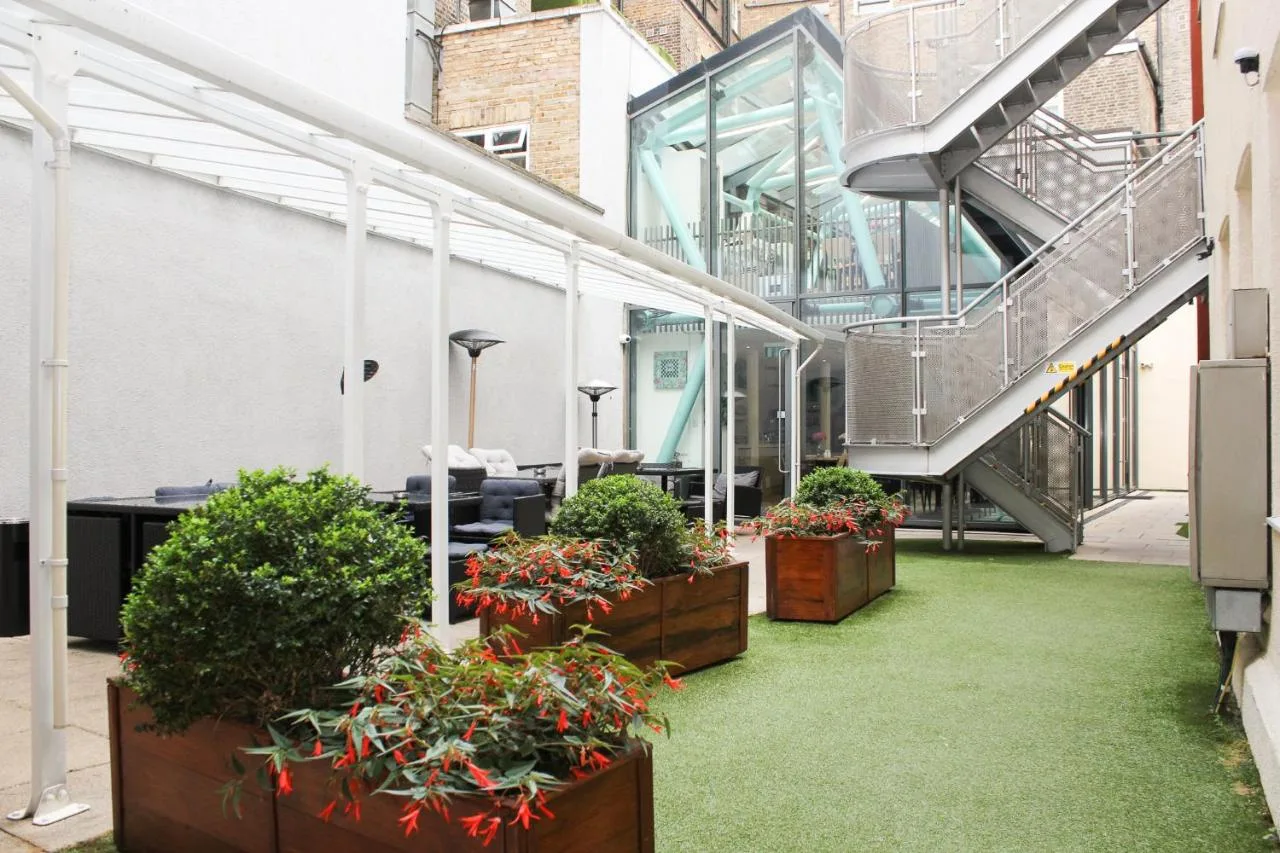 a greenhouse with potted plants in a building at Grand Plaza Serviced Apartments in London